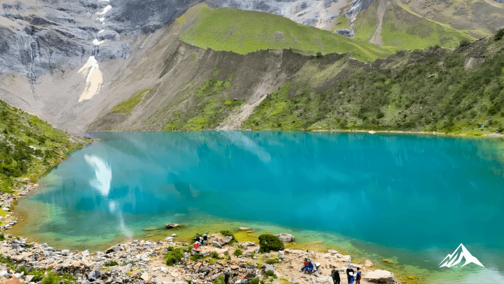 Panoramic view of the turquoise Humantay Lake at the foot of the snow-capped Salkantay mountain in Peru.