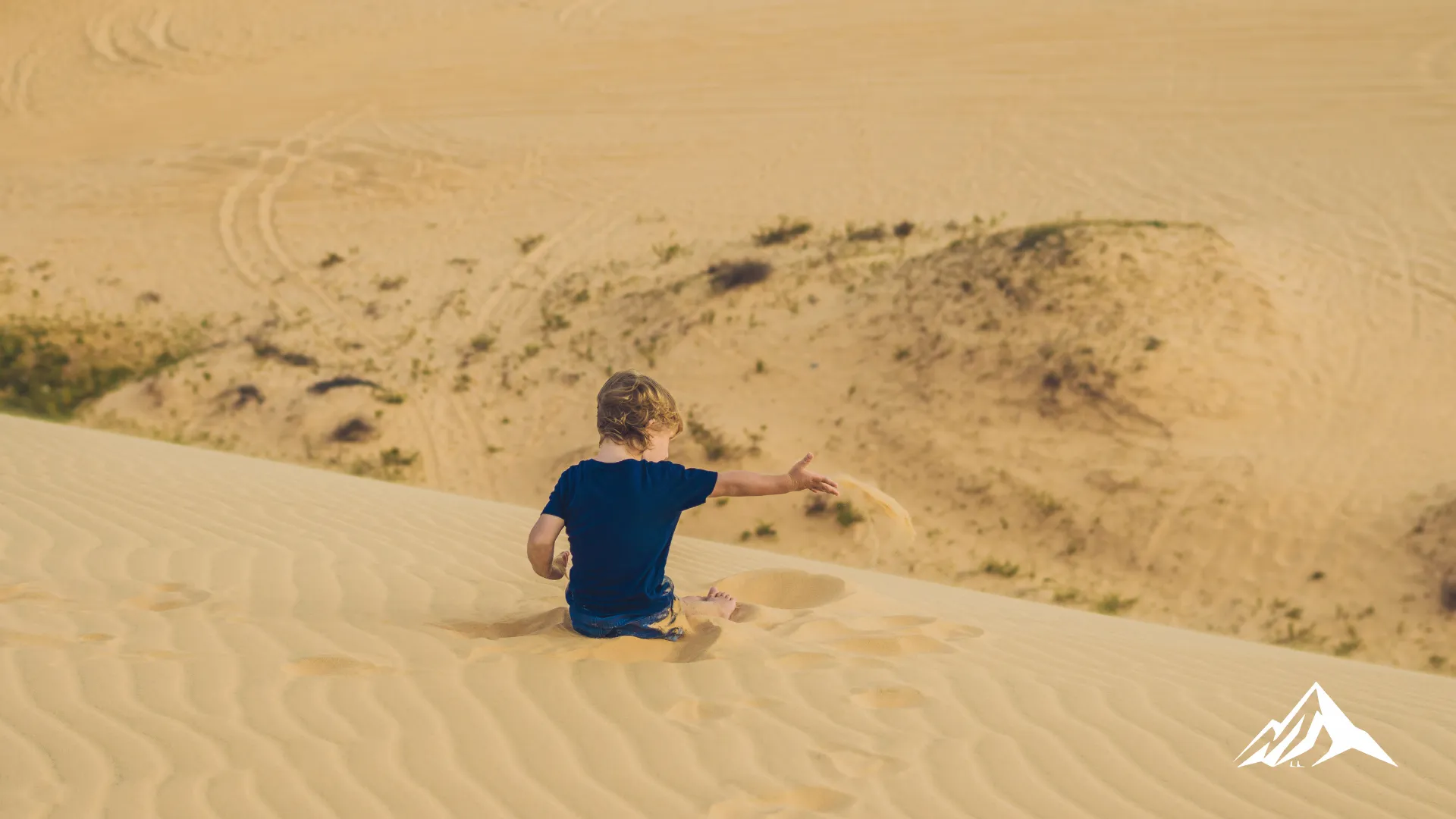 Child exploring the sand dunes of Huacachina during a family vacation
